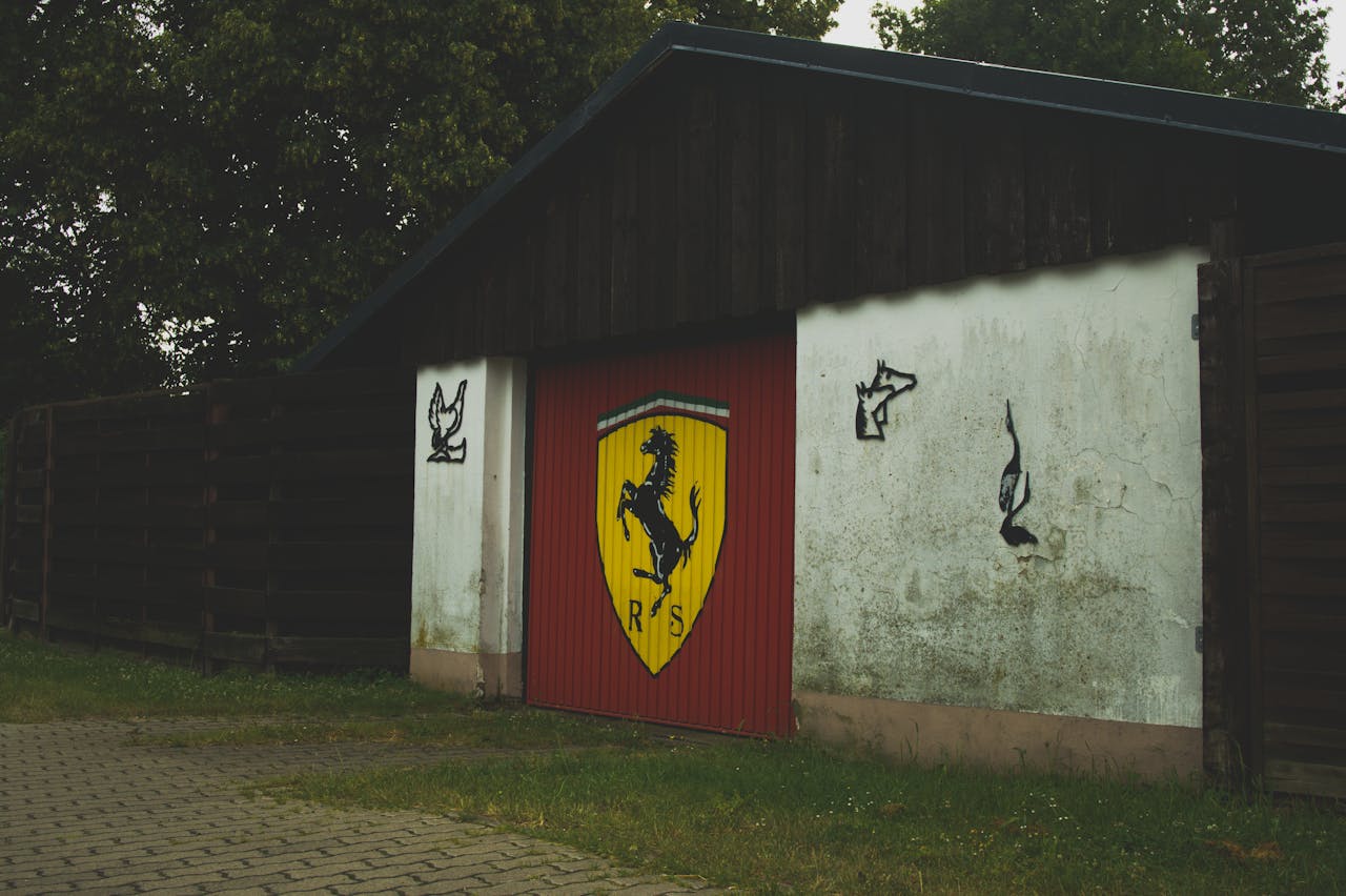 Red garage door with horse emblem and artistic graffiti in German suburb.